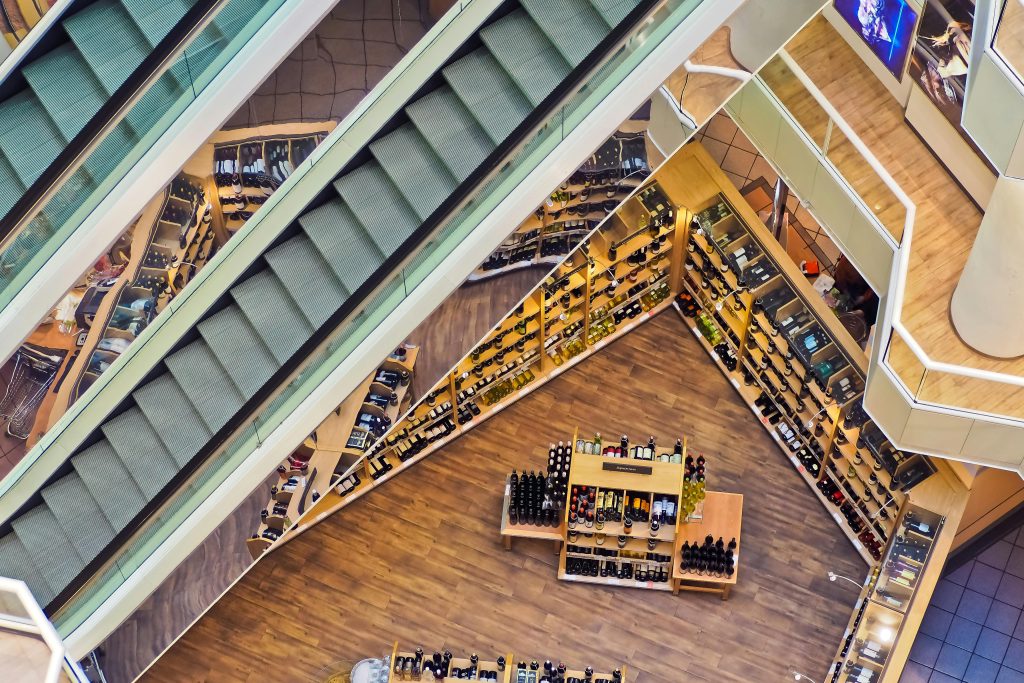 pexels-photo-264507-264507 Aerial view of a stylish shopping mall showcasing escalators and well-organized retail displays.