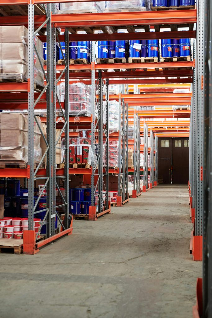 pexels-photo-4483609-4483609 Industrial warehouse interior with organized shelves stacked for services
